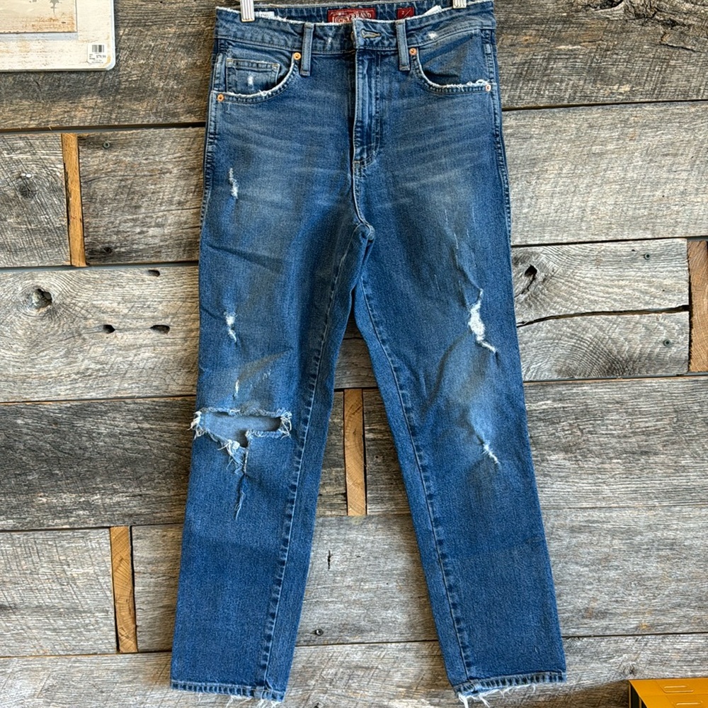 Lucky Brand ripped jeans with light wear.